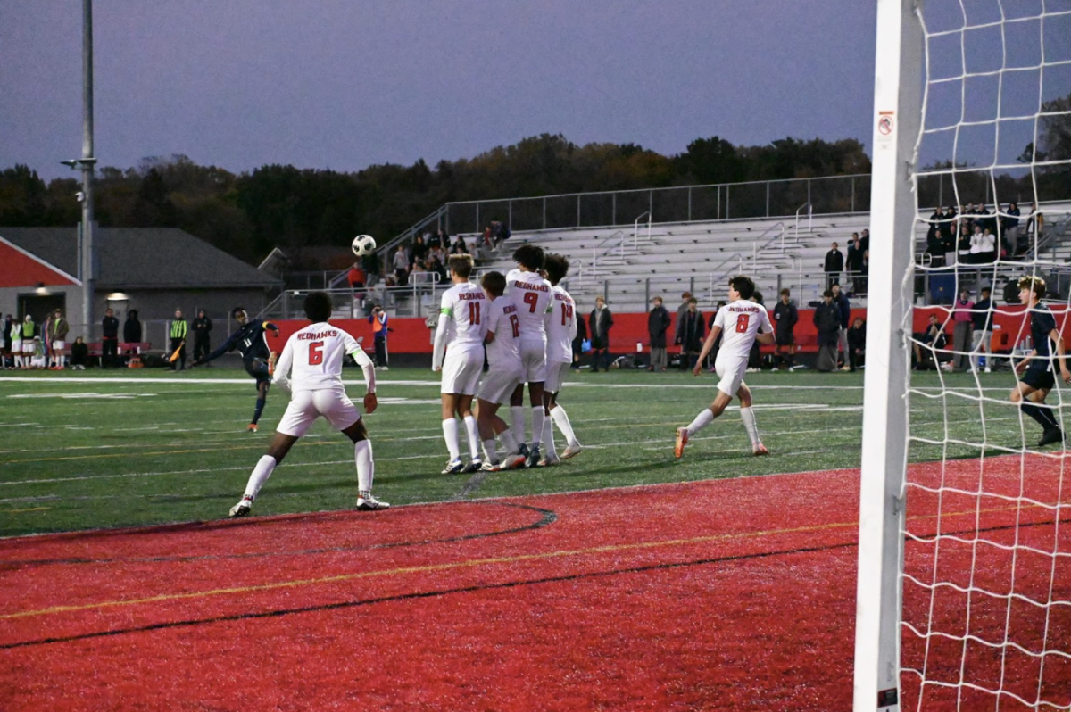 SIDESPIN SHOT. Senior Ezra Straub loops a free kick over the top of a Minnehaha wall. The ball was saved by the goalkeeper but was a great chance and a shot on goal for the Spartans in the second half.