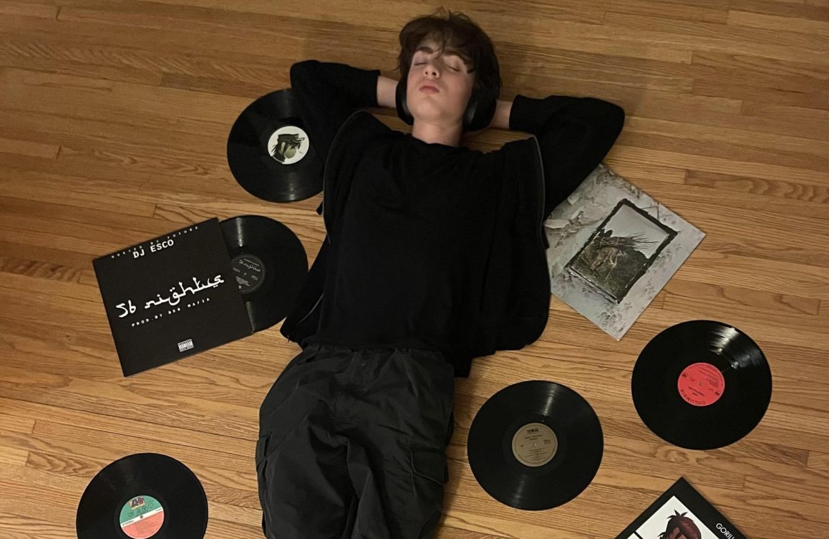 TIME FOR A THROWBACK. Junior Eli Henretta relaxes at home surrounded by records old and new alike.
Submitted photo: Eli Henretta