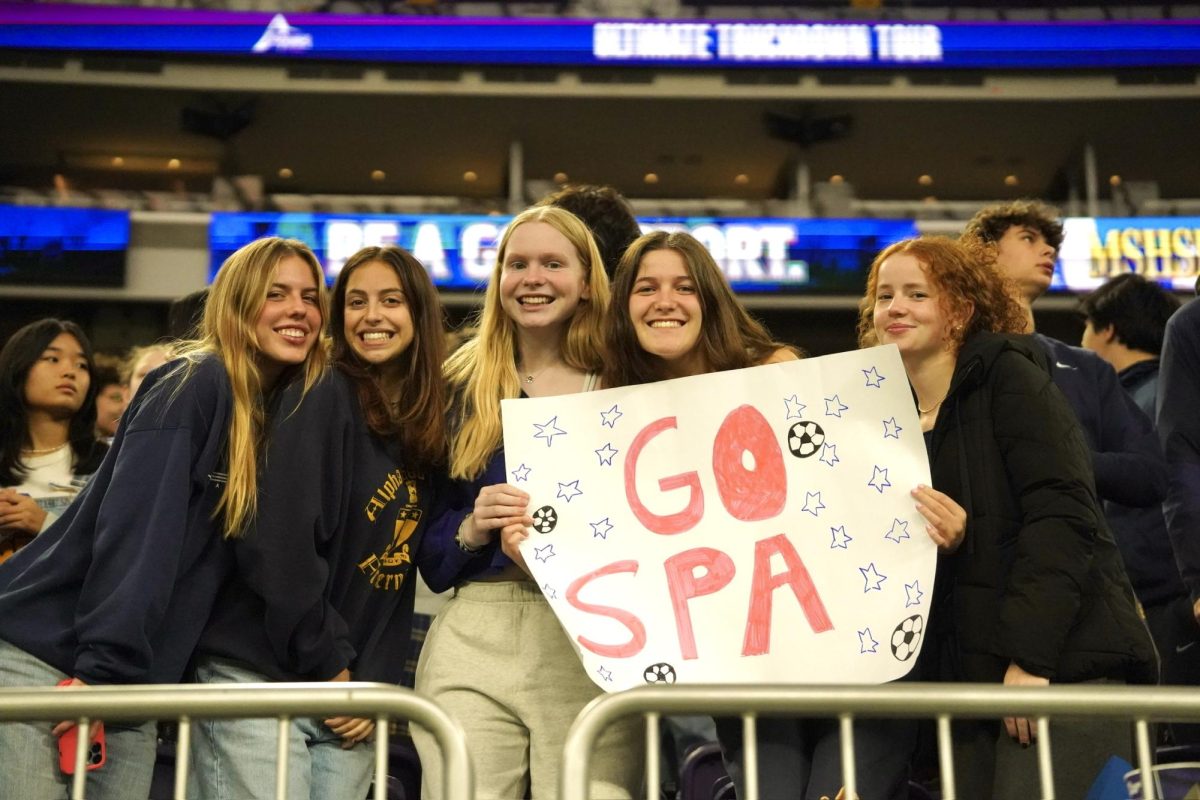 CHEESING'. Spartans' rally with smiles and signs to cheer on the boys' to state.