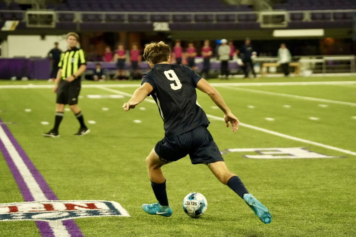 PRIDE SHOT. Senior Ethan Peltier strides with pride to attempt a shot on goal.