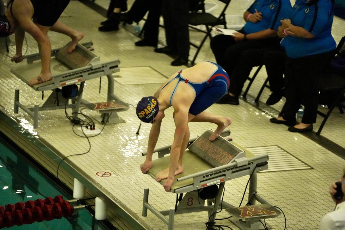 TAKE YOUR MARK. Gjerde takes her position as the starting official signals the start with a buzzer.