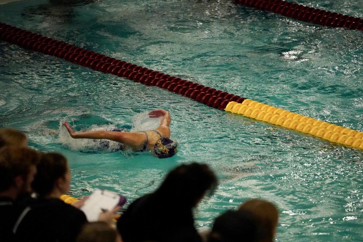 WINGS OUT. Gjerde flies through the water, completing the first 25 yards out of 100 in her event.