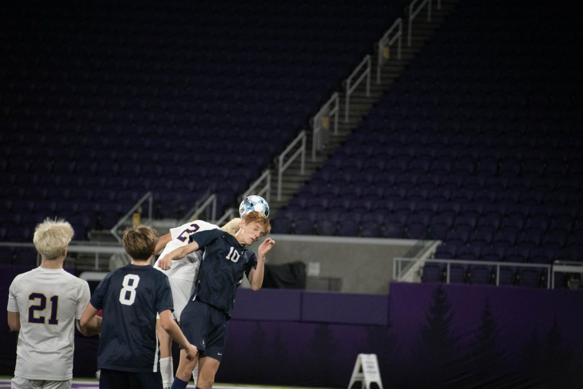 HEADS UP. Freshman Graham Waibel jumps up for a header against an opposing player.  