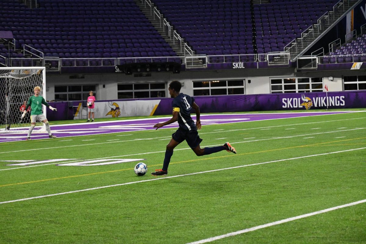 SPRINT. Captain Ezra Straub finesses the ball past the Lourdes defender as he hurdles toward the opposing team's goal. Straub was selected for the 2024 All-Tournament Team as well as teammates Rowan McLean, Liam Sullivan, and Arlo Zirps.