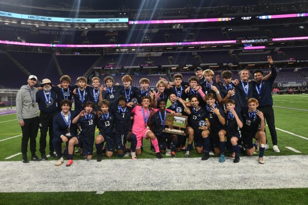 TRIPLE CROWN. BVS celebrates their third consecutive state tournament win. Some players hold up three fingers and bite their medals in celebration.