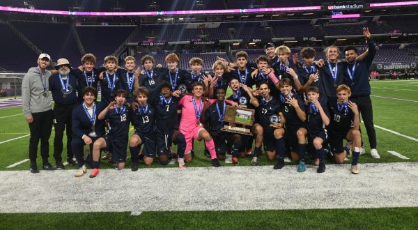 TRIPLE CROWN. BVS celebrates their third consecutive state tournament win. Some players hold up three fingers and bite their medals in celebration.