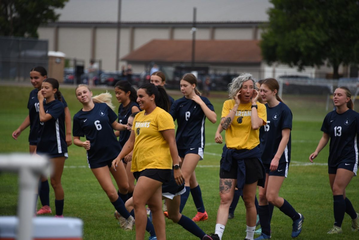 SISTERS IGNITE EXCITEMENT. Coaches and sisters Aileen and Rycke Guiney lead the girls varsity soccer team with energy and excitement as they fight for another win.