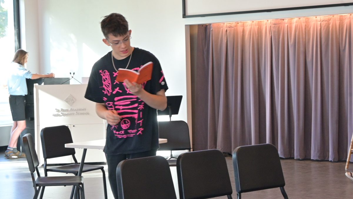 WELCOME TO OUR TOWN. Coda Wilson reads a piece of his Stage Manager narration at an Our Town practice in Redleaf Commons. The show includes a minimalist set and no props, so much of what the audience will visualize comes from Wilson's lines.