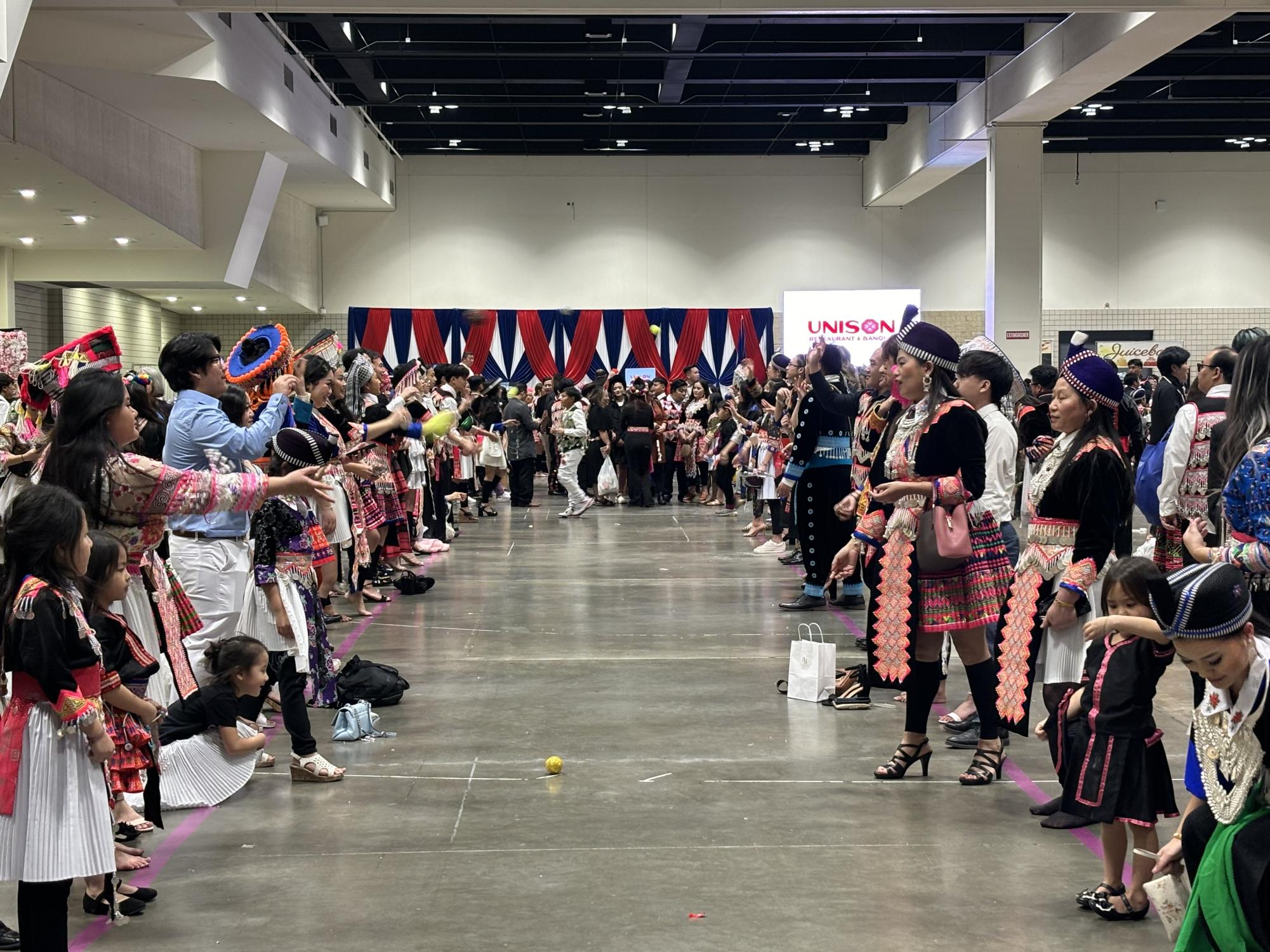 BALL TOSS. People at the Hmong New Year celebration at RiverCentre in downtown Saint Paul play pov pob, a game that involves tossing a ball back and forth. Traditionally, it is a game of courtship.