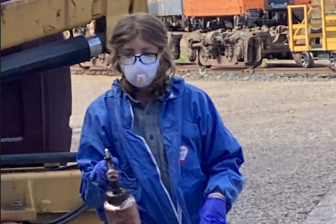 HARD AT WORK. Ninth grader Hank Harp works on fixing a train. Harp utilizes mechanical tools that require skill to handle.