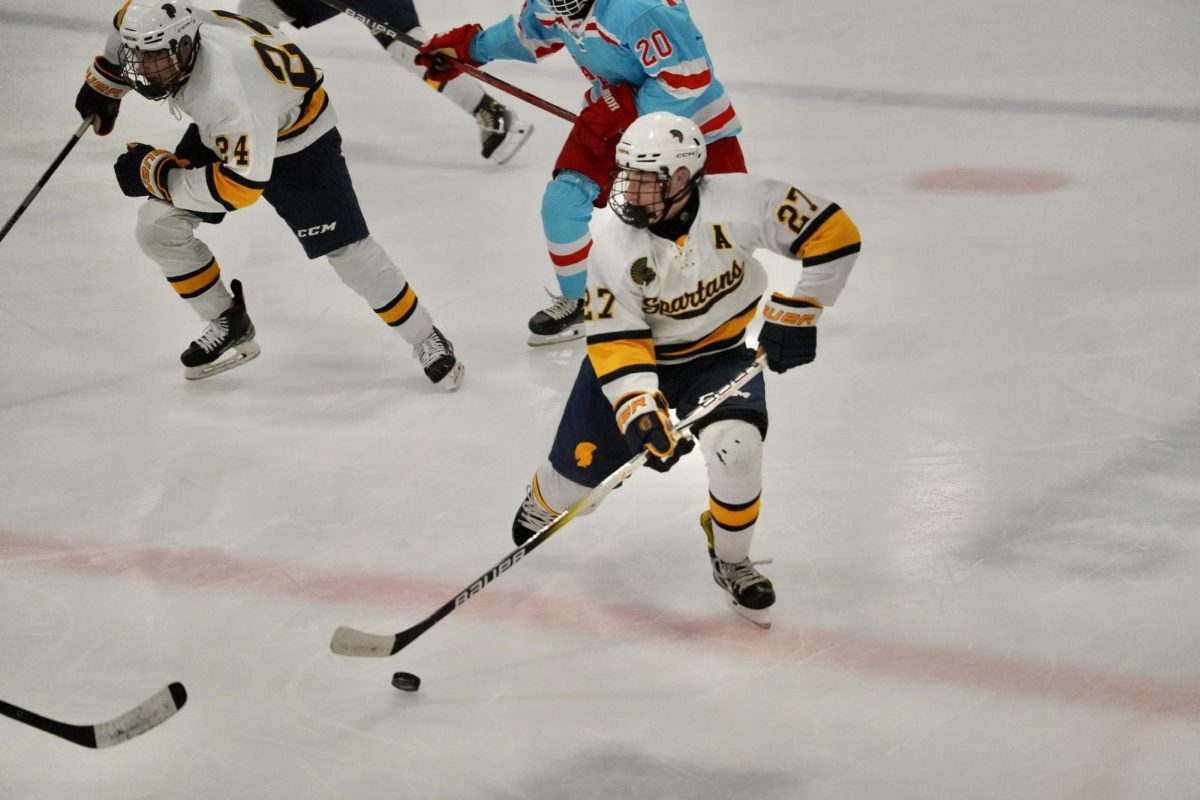 LOOKING FOR OPTIONS. Senior forward, Preston Karelitz looks for opportunities on who to pass the puck to. 