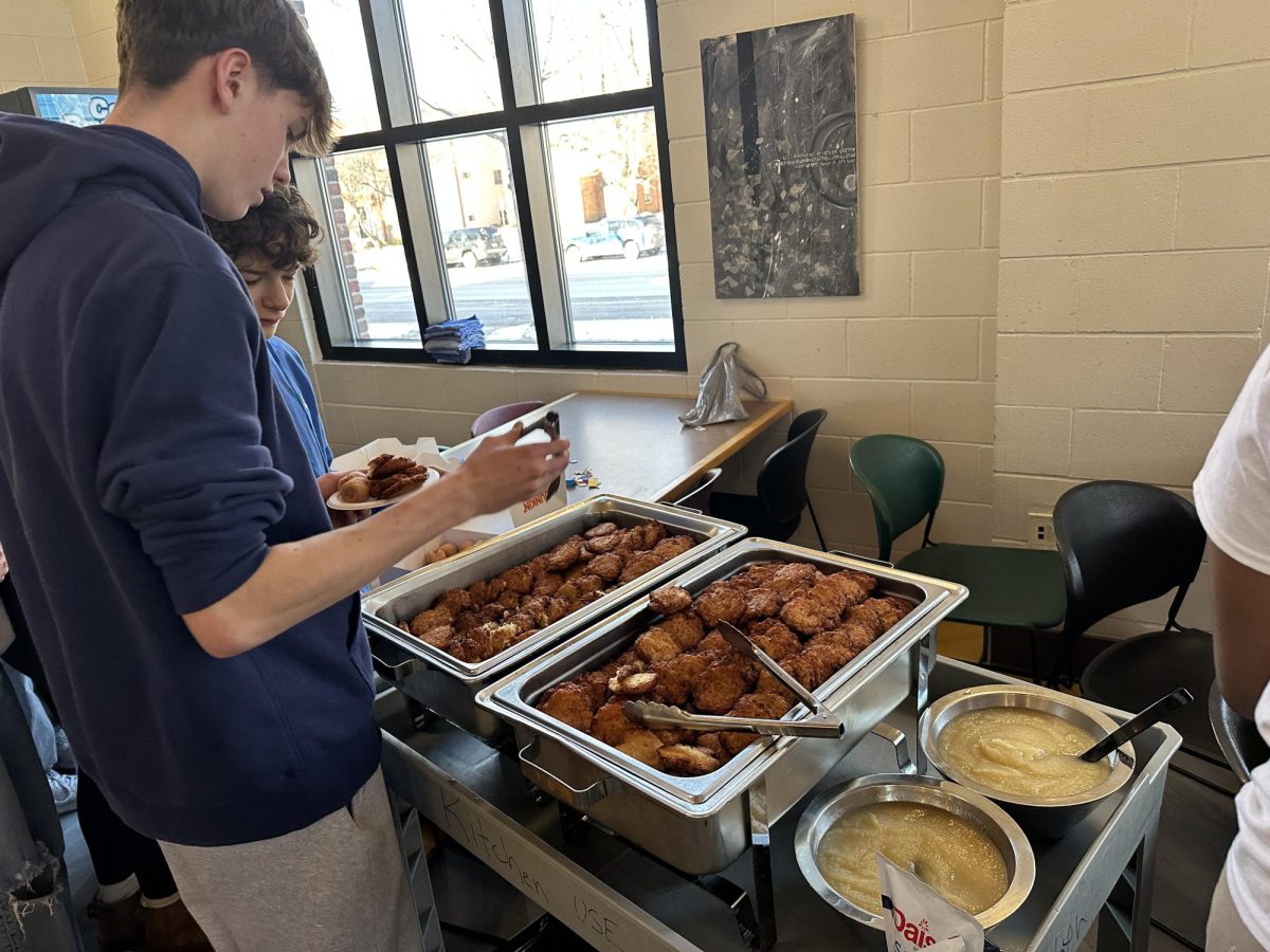 EAT. First-years Sam McCarthy and Landon Hide serve themselves latkes. 