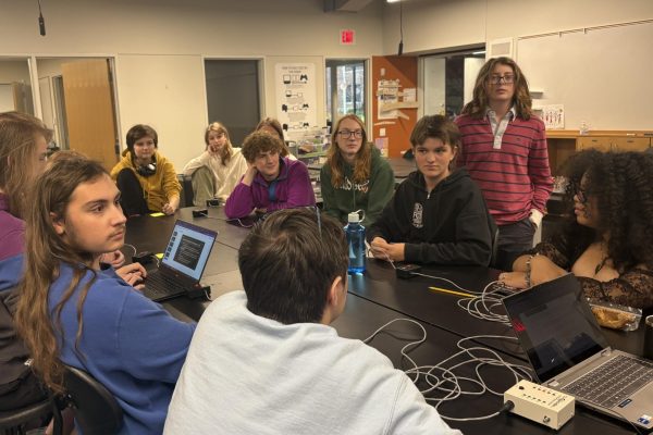 PRACTICE MAKES PERFECT. The Quiz Bowl team sits around a table practicing questions together.