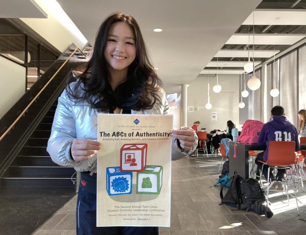 THE DESIGNER. Kalugdan holds the first printout of the poster she designed for the conference.