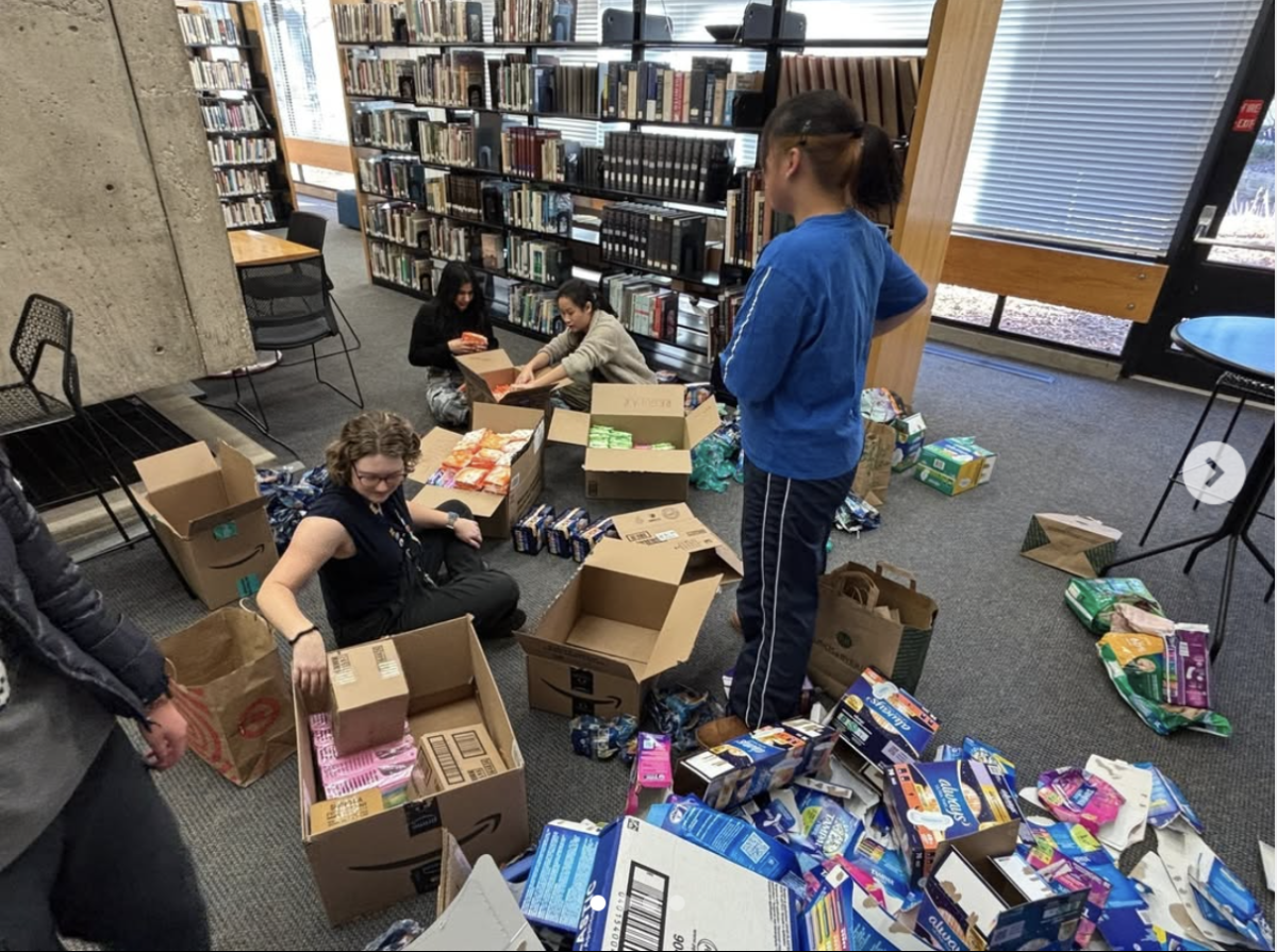 USC members prepare for Service Day by unpacking all the donations they received. Recycling and trash cans overflowed with empty cardboard boxes and plastic bags in the lower library. USC co-vice President Carys Hsiung spent an hour and a half with other members sorting through the donations. “I’m looking forward to see how many kits we pack and how we transform the 14,000 plus period products,” Hsiung said.