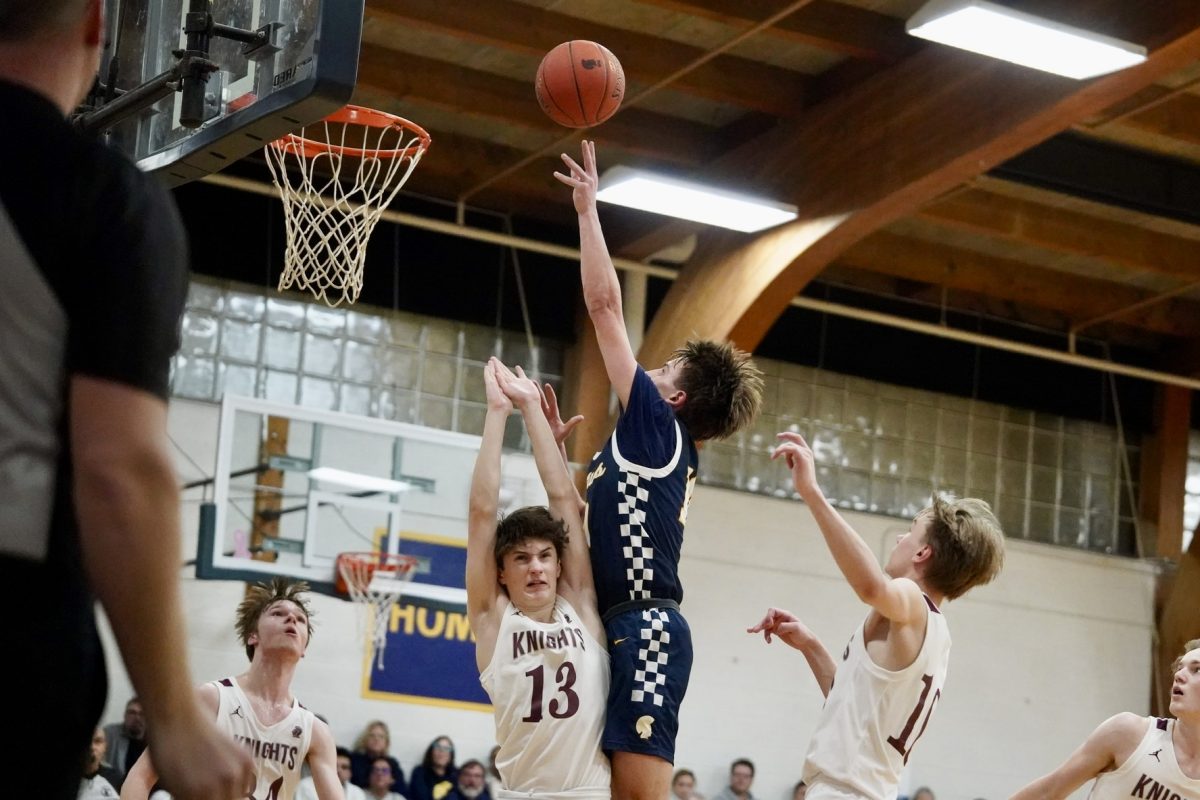 TIP-IN. Sophomore Miles Vogenthaler tips the ball while jumping up.